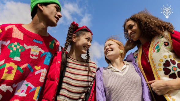 Group of diverse teens smiling and socializing outdoors, representing friendship, confidence-building, and social skills development for teens with autism.