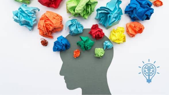 Silhouette of a human head with colorful crumpled paper symbolizing thoughts, representing executive dysfunction challenges.