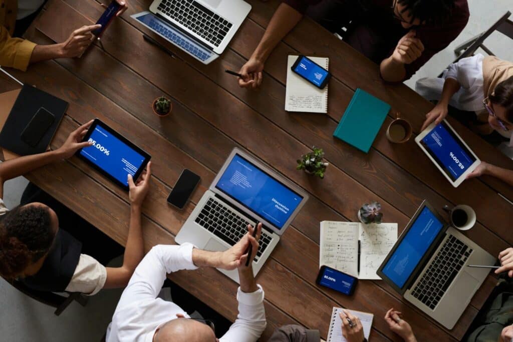 meeting board with multiple members using electronic devices