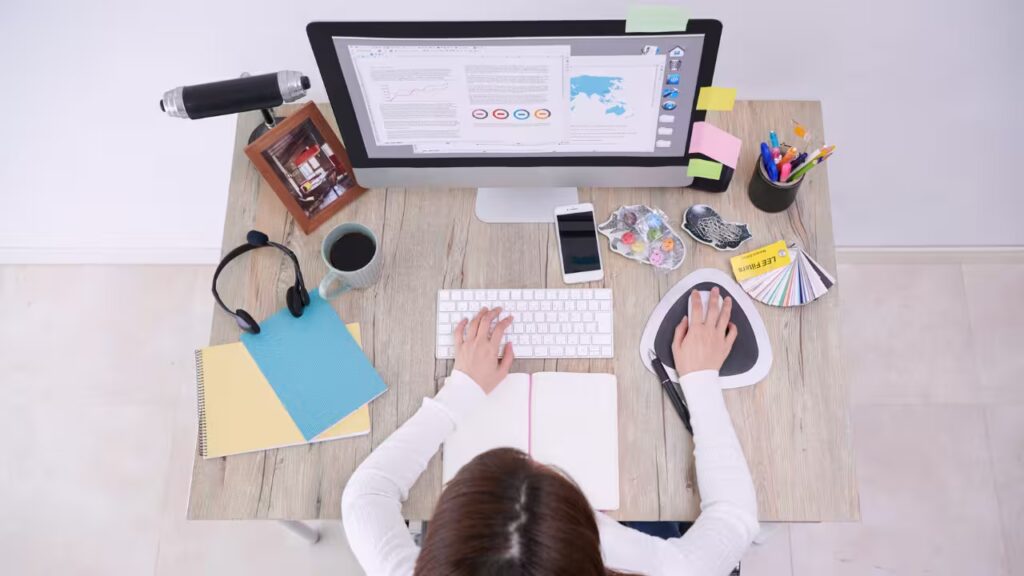 Top-down view of an organized workspace illustrating how the best ADHD tools & apps integrate with planners to improve focus and productivity.